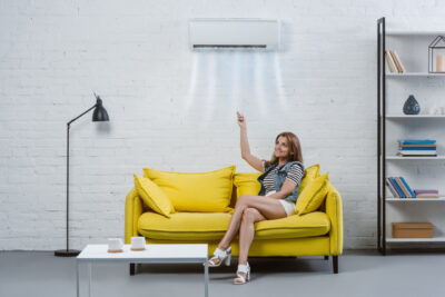 rsz attractive young woman pointing at air conditioner utc x